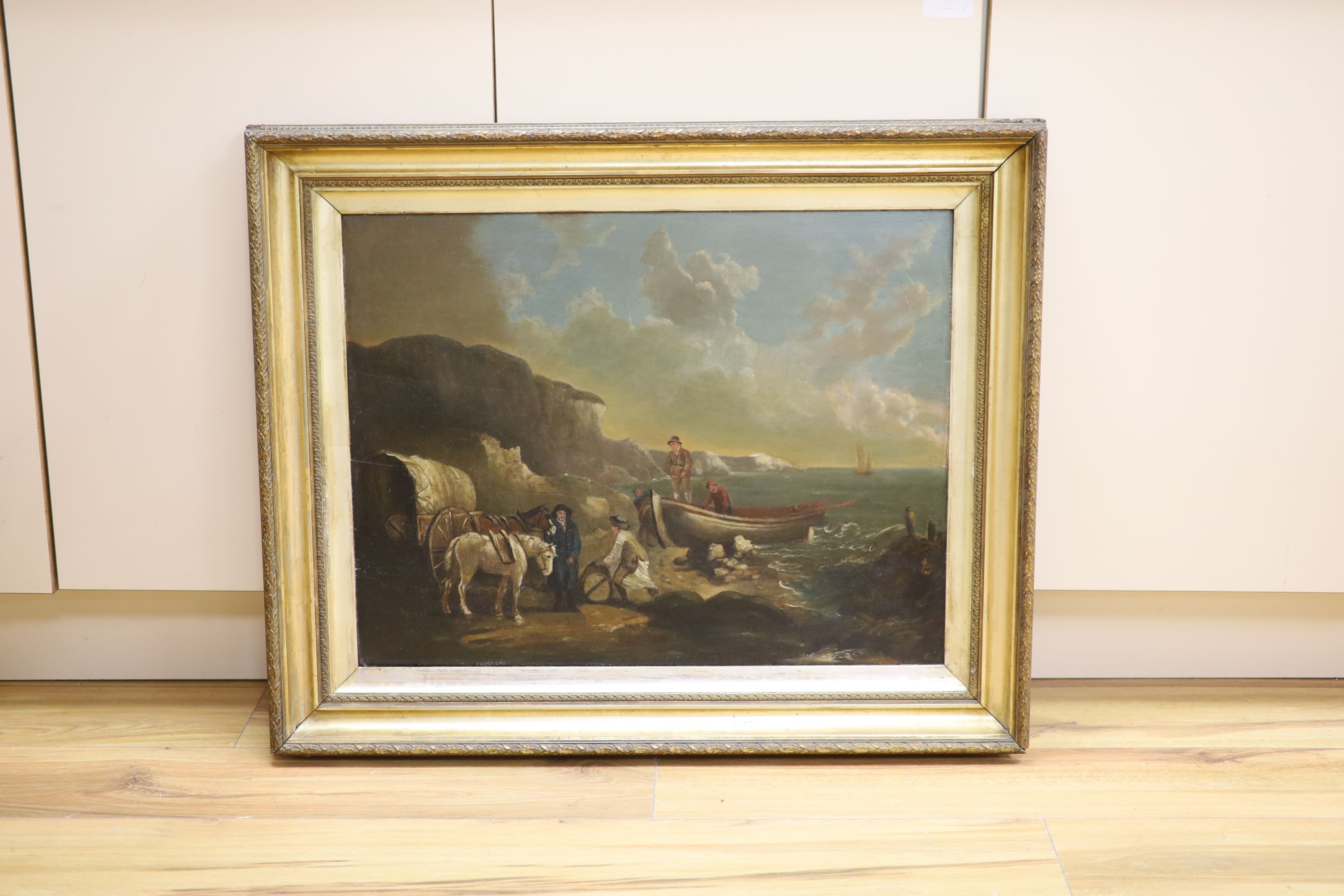 Follower of William Shayer (1811-1892), oil on panel, beach scene with smugglers unloading their haul, 48.5 x 63.5cm